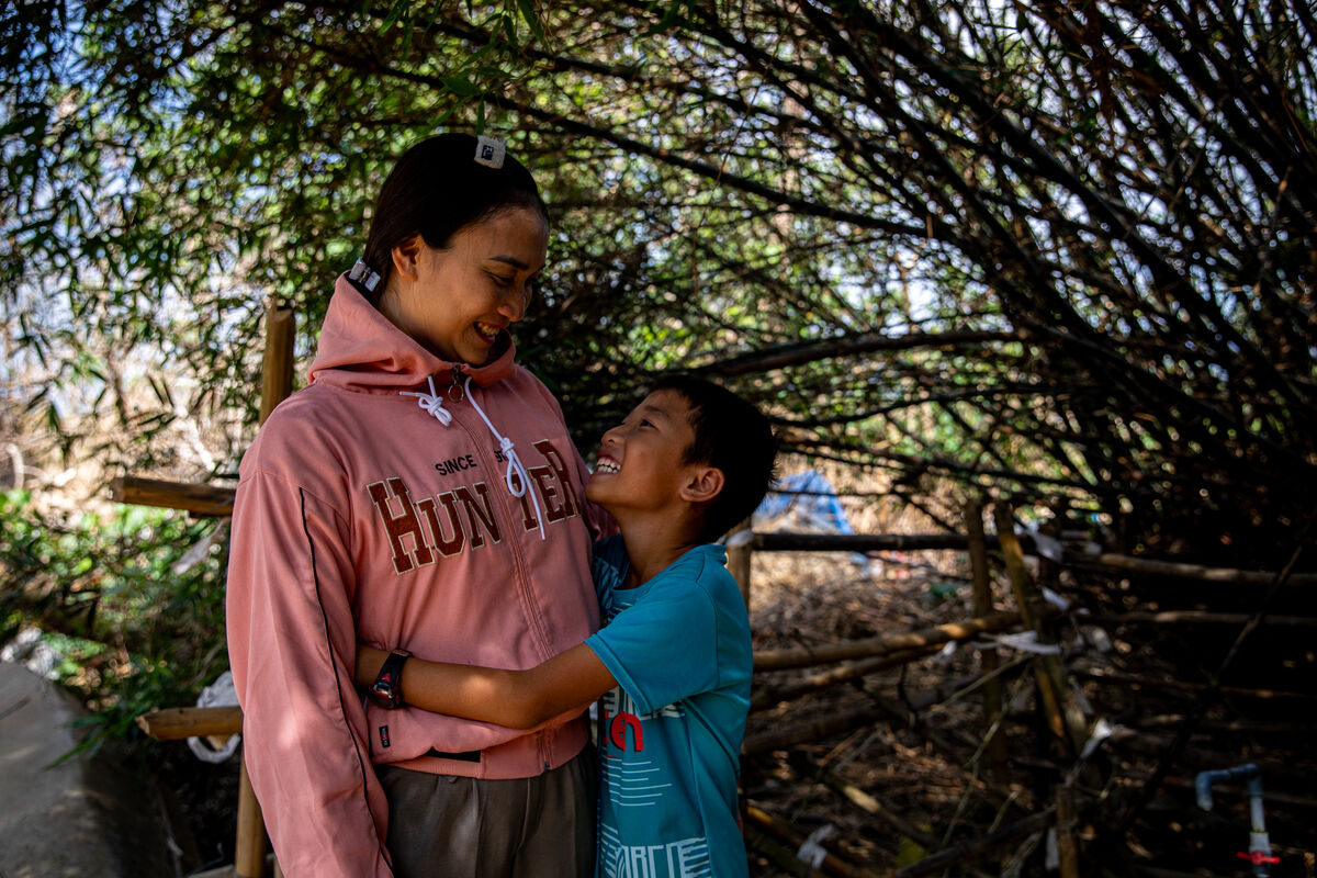 Mati objema svojega sina in se smejita en drugemu.