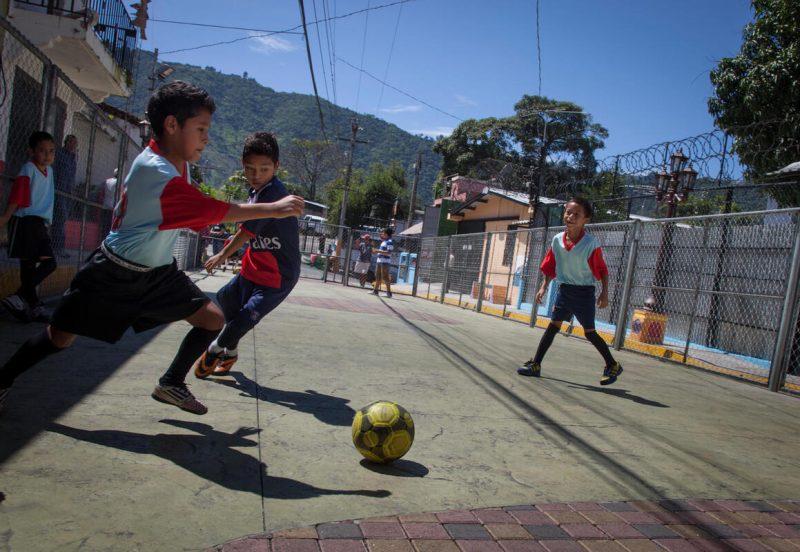 Na ulici v San Marcosu v Salvadorju dečki igrajo nogomet na obnovljenem javnem igrišču, ki ga je podprl UNICEF v sodelovanju z lokalno občino.