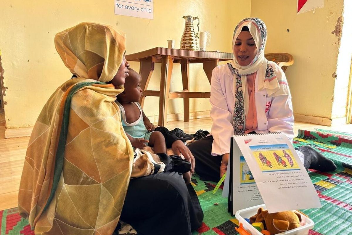 Prehranska svetovalka Rayan se pogovarja z Iqbal, ki v naročju drži svojo 9-mesečno hčerko Layan, v zdravstvenem centru Bir Hamad v Sudanu.