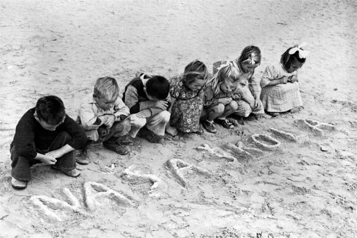 Otroci pred napisom "naša škola"